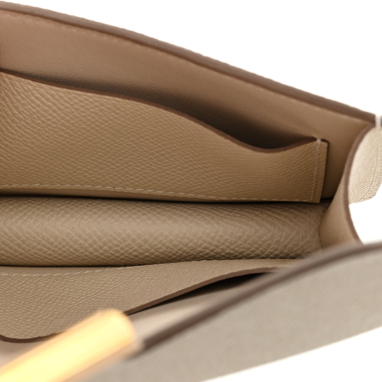 Slim wallet interior with stitched seam, light cream textured leather