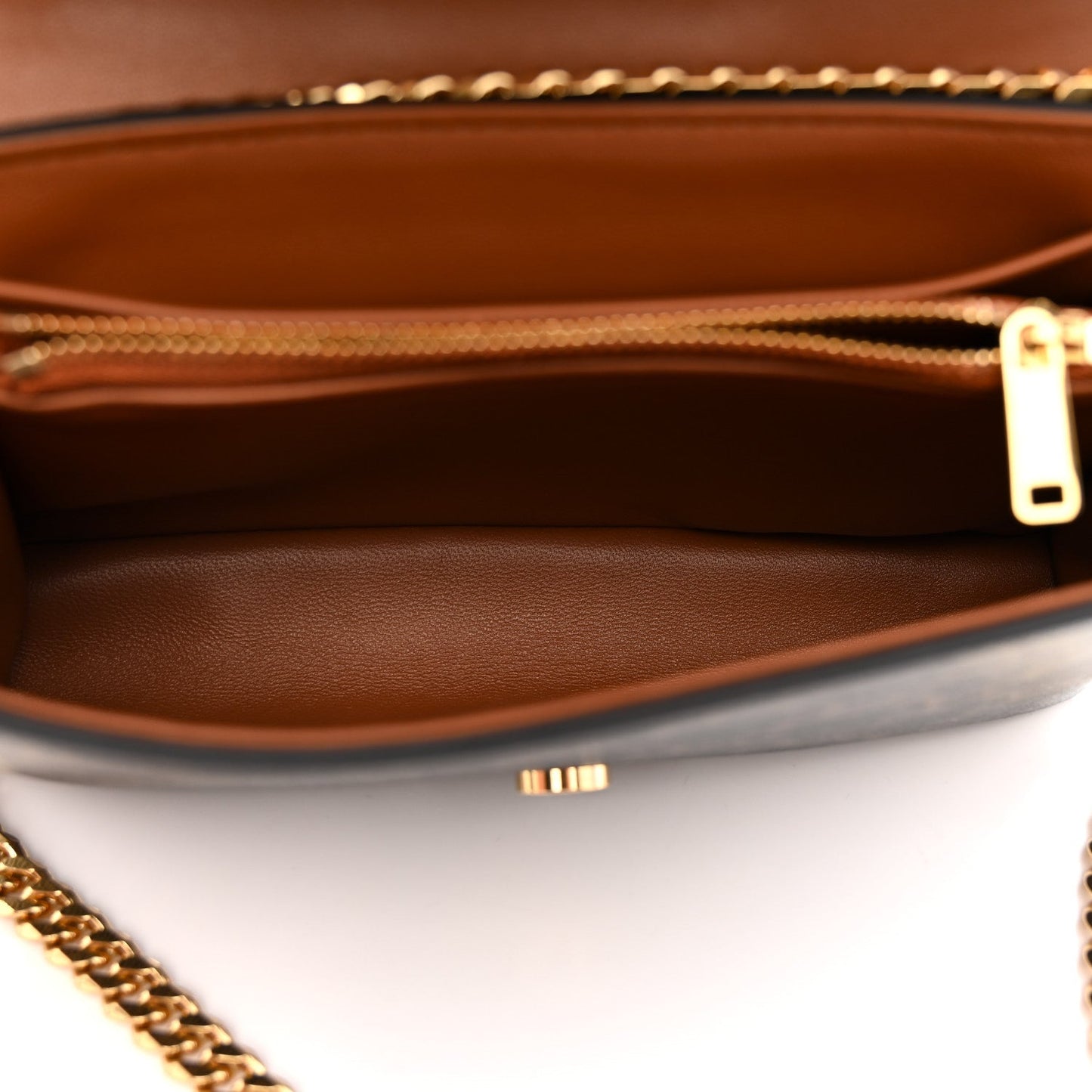 Celine Triomphe shoulder bag interior view with tan lining and gold zipper pull