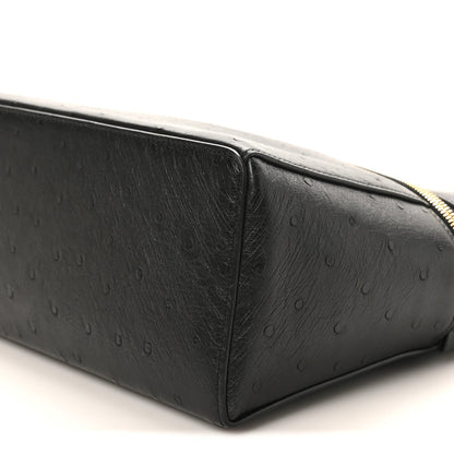Black ostrich leather side panel with textured finish and curved top seam.