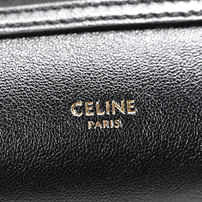 Celine black leather logo plaque reading “CELINE PARIS”