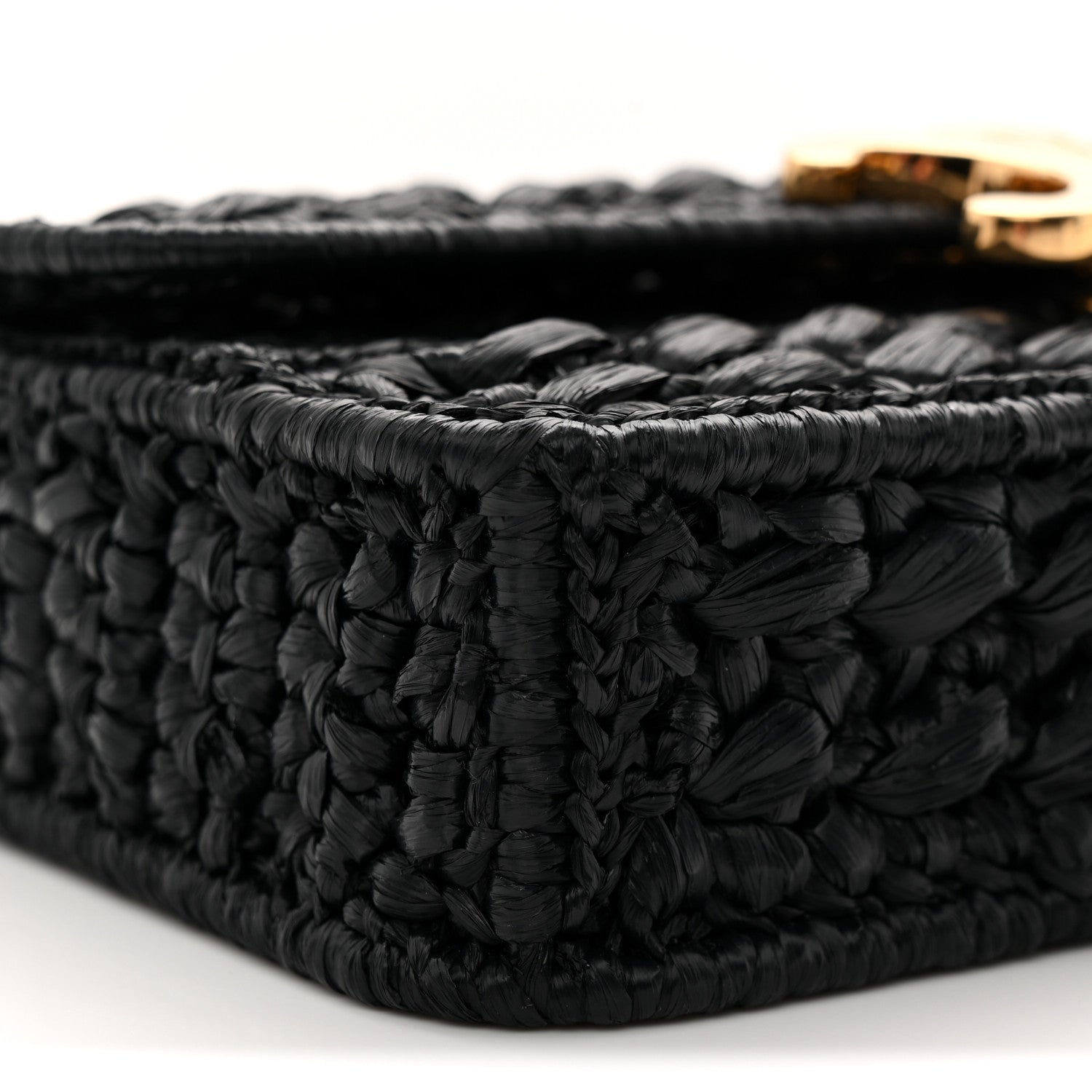 Black raffia-effect woven corner detail with raised texture