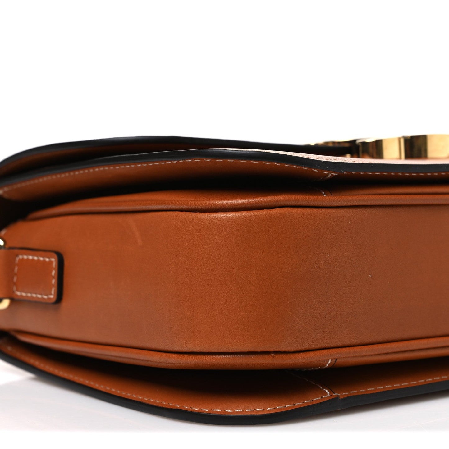 Tan leather crossbody bag showing top closure, gold-tone hardware, and stitched edges.