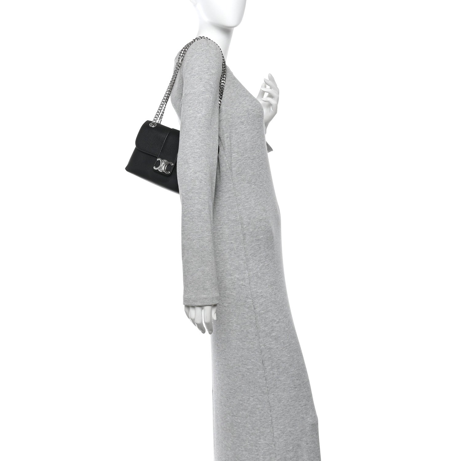 Black leather shoulder bag with chain strap, worn crossbody by model