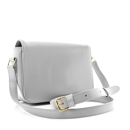 Shiny calfskin shoulder bag with adjustable strap and gold-tone buckle