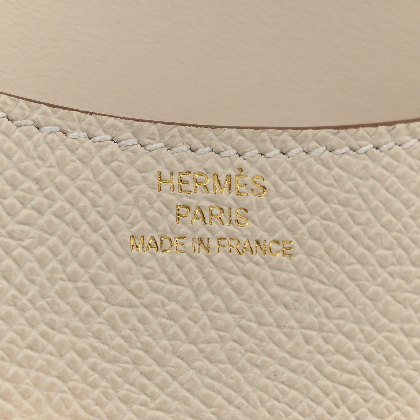 Hermès PARIS MADE IN FRANCE embossed on light cream textured leather