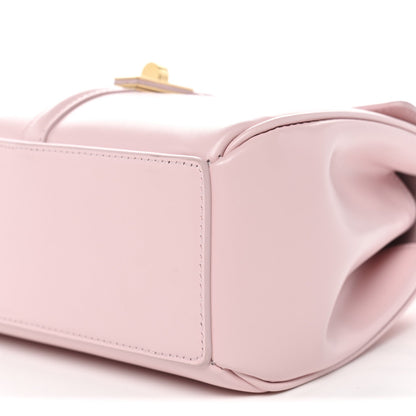 Pastel pink mini bag close-up with seam stitching and opening at top edge