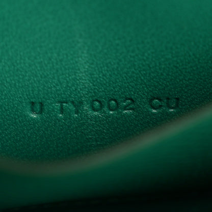 Green leather emboss mark with small printed characters