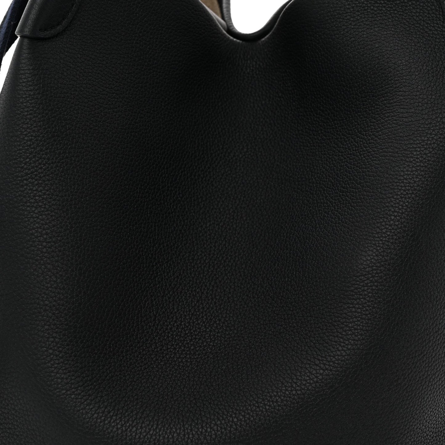 Grained dark navy leather exterior close-up with curved opening and seam