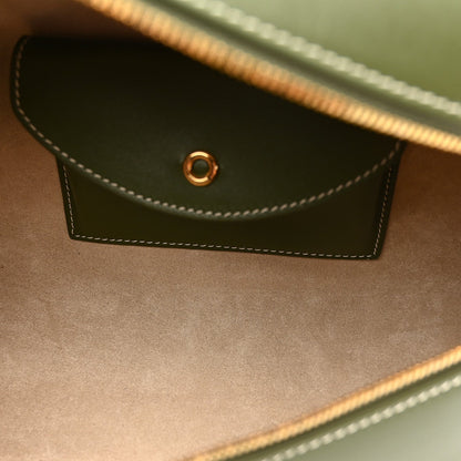 Olive green leather front flap pocket with contrast stitching and small metal ring