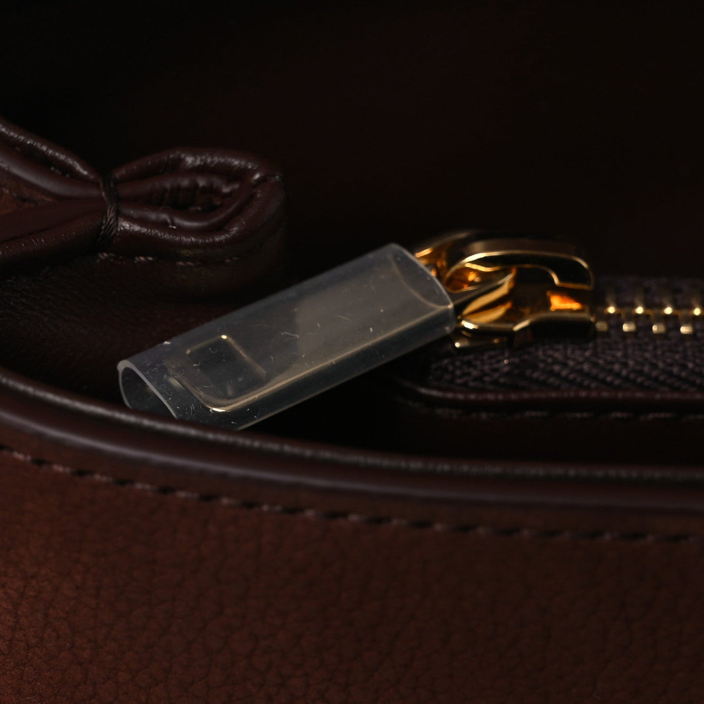 Chestnut leather bag zipper pull with gold rings and metal tab