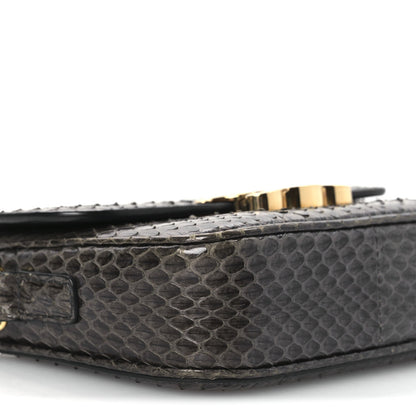 Grey snakeskin bag bottom edge with gold-tone hardware and stitching