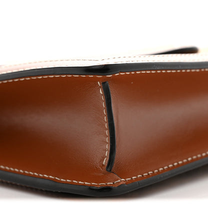 Brown leather wallet corner with edge seam and rounded bottom profile