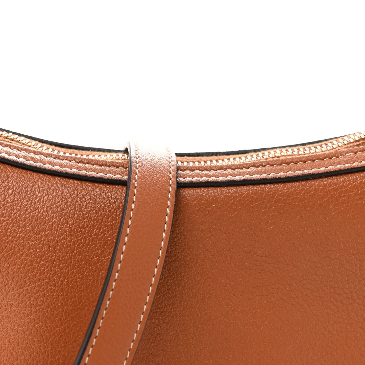 Tan leather bag top with stitched handle attachment and matching crossbody strap