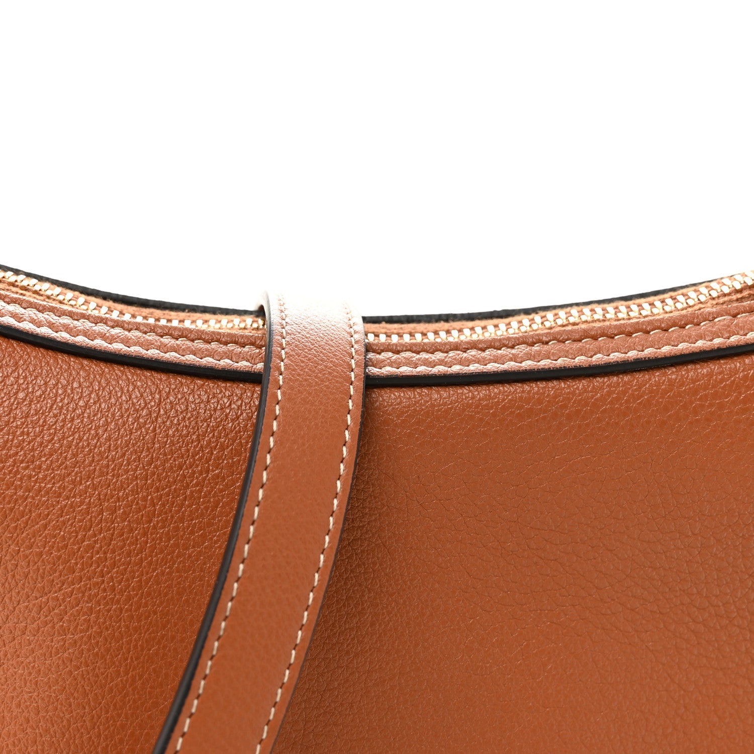 Tan leather bag top with stitched handle attachment and matching crossbody strap