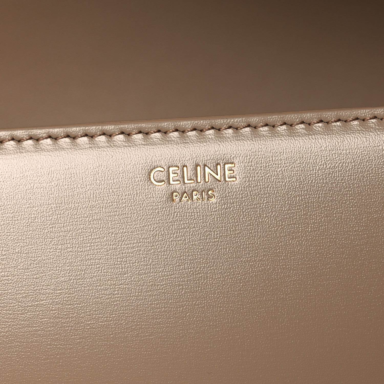 Celine Paris embossed on beige leather with visible edge stitching