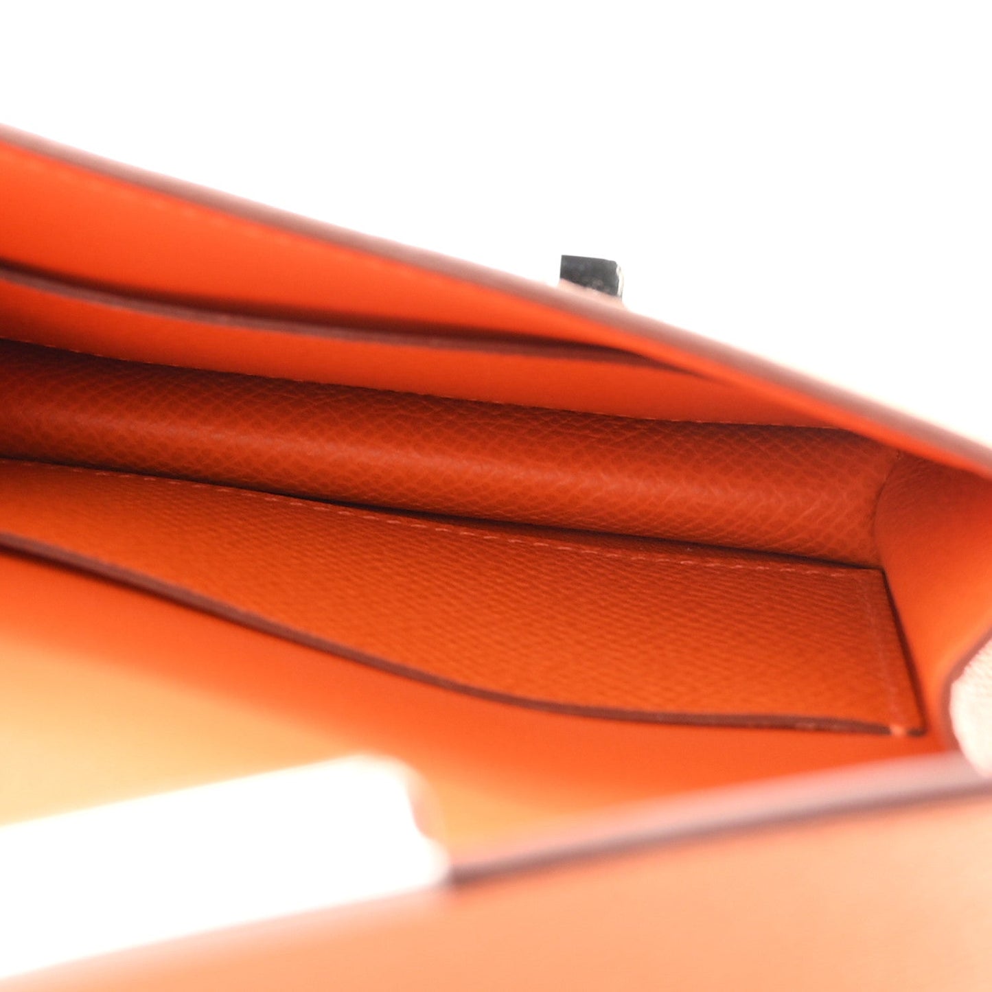 Orange Epsom leather slim wallet interior edge seam close-up.