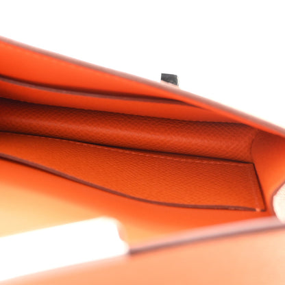 Orange Epsom leather slim wallet interior edge seam close-up.