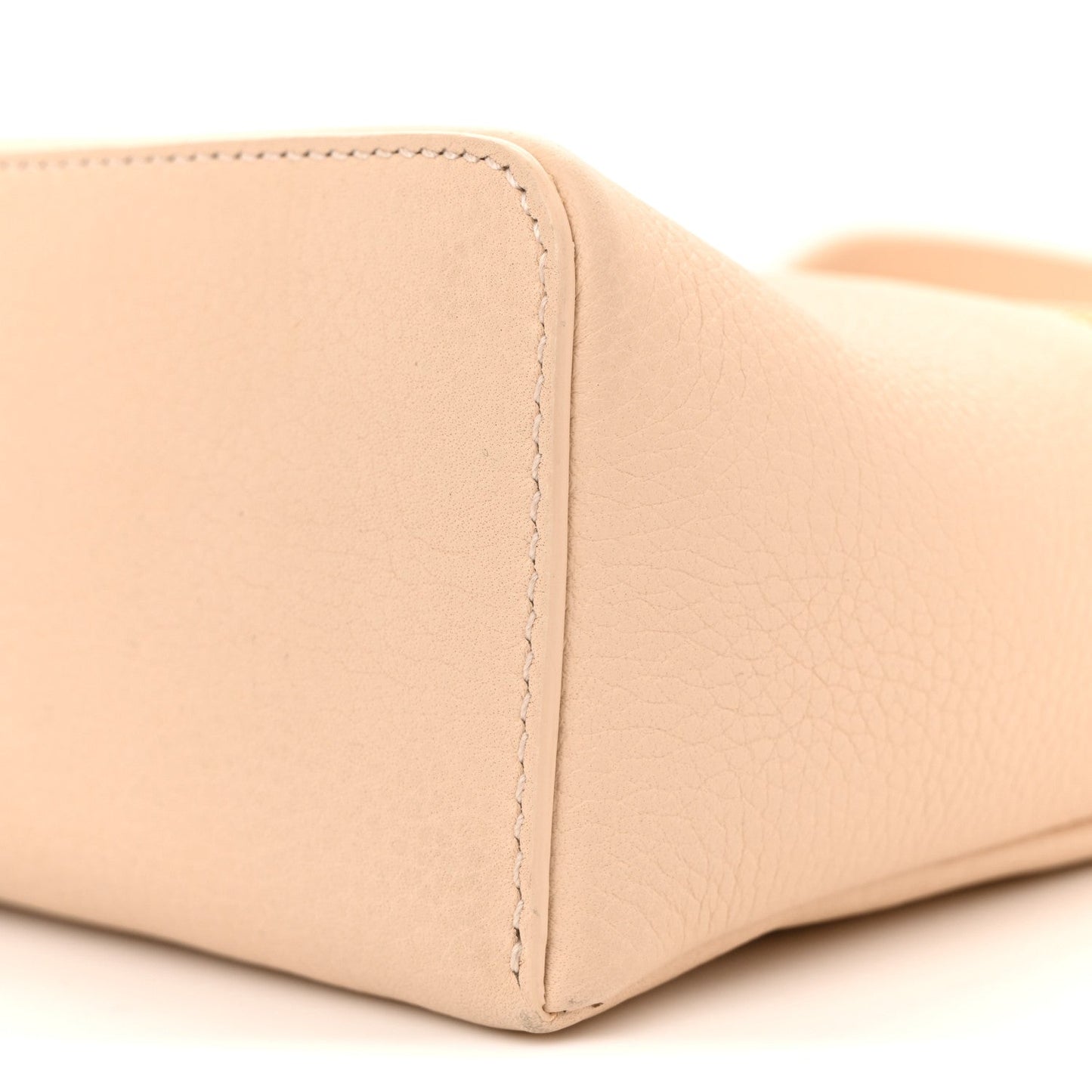 Cream leather pouch base corner with seam and textured grain