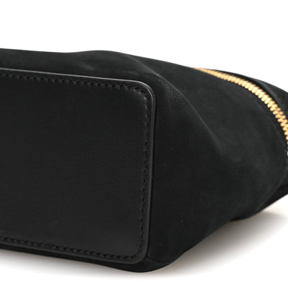 Black nubuck pouch side seam with gold-tone zipper edge