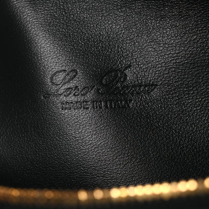 Loro Piana engraved on black grained calfskin pouch surface near the gold zipper