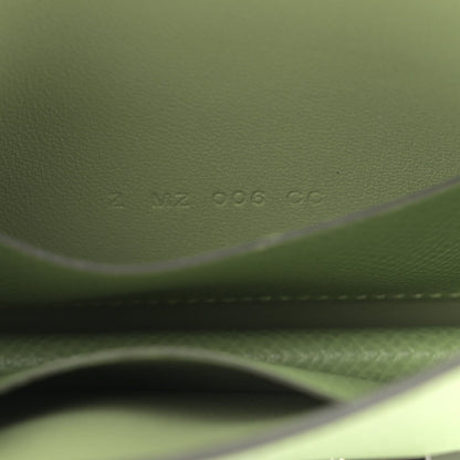 Light green leather wallet close-up of embossed code and stitching
