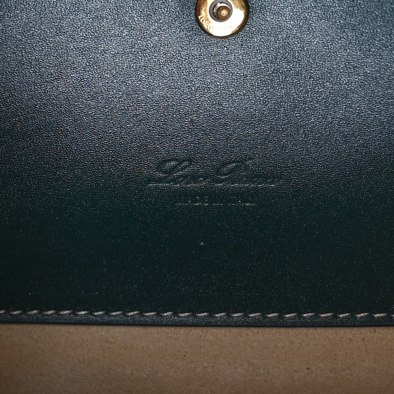 Petrolio teal leather bag exterior closeup with embossed logo and stitching