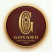 Goyard logo on a round, maroon background with gold border