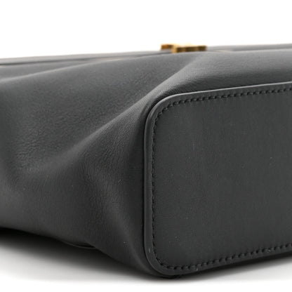 Black leather rectangle bag side corner with rounded panel and edge stitching