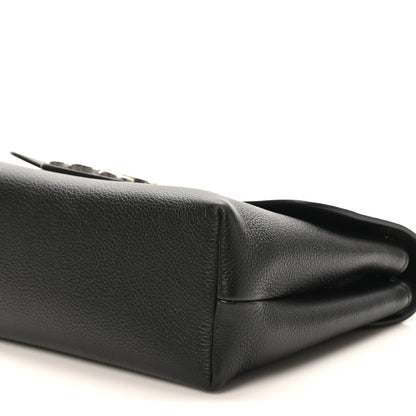Black calfskin bag side close-up with stitched panel and folded edge