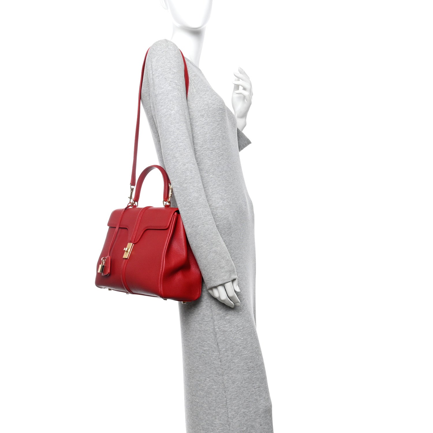 Red leather top-handle bag worn on model, side view with shoulder strap