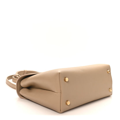 Beige Nino safari bag bottom corners with gold feet and side panel