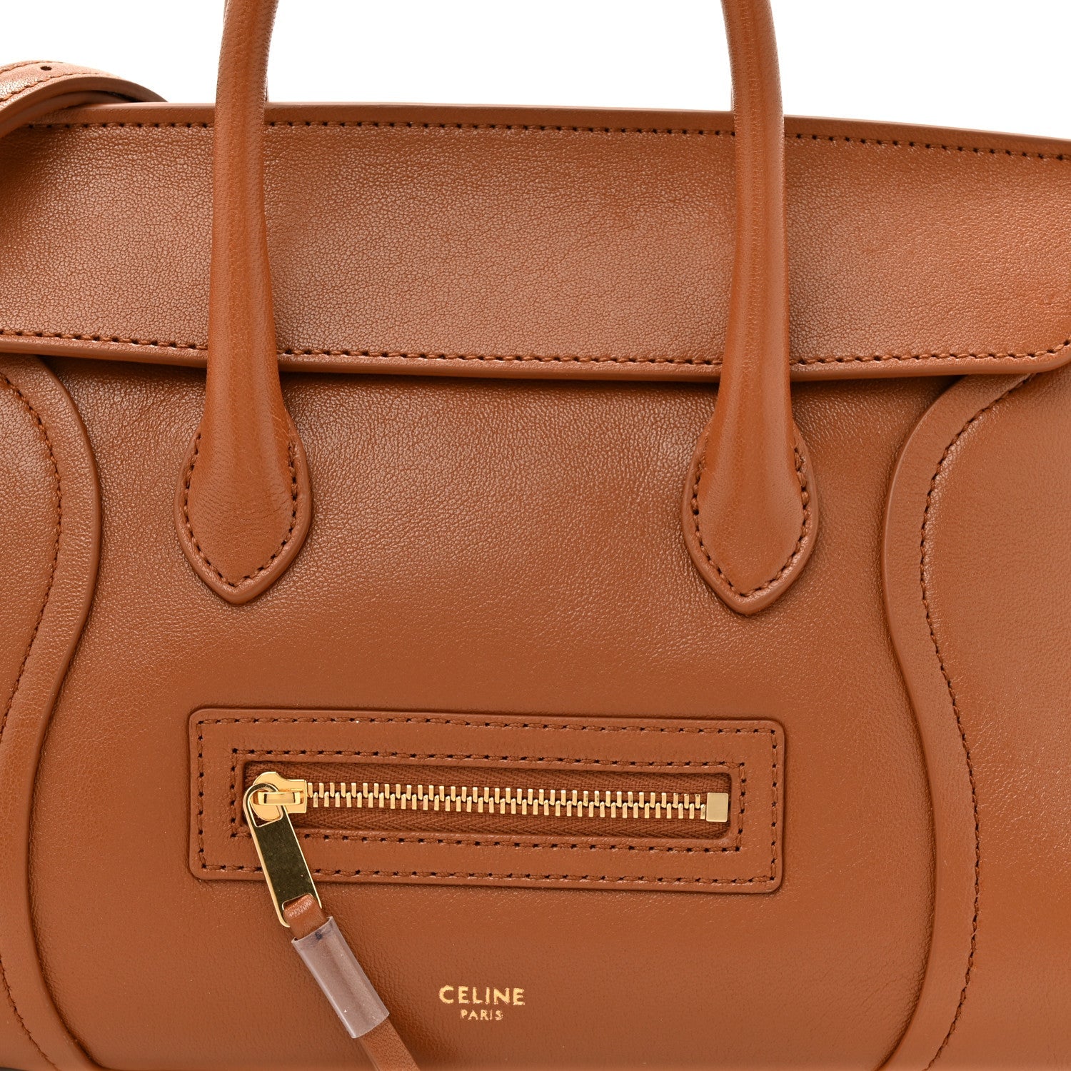 Tan leather handbag front zip pocket with Celine Paris logo and gold zipper pull.