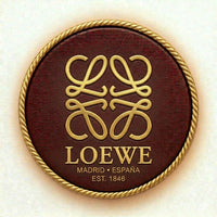 Loewe logo on a round brown leather patch with gold border