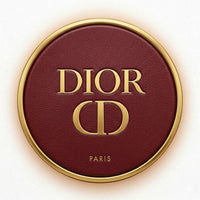 Dior makeup compact with gold border and logo on a white background